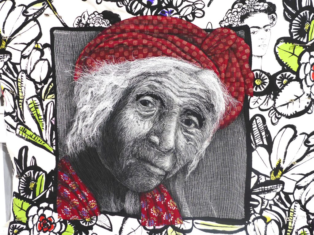 Quilt created by Pam Holland inspired by her own photograph taken of an elderly woman