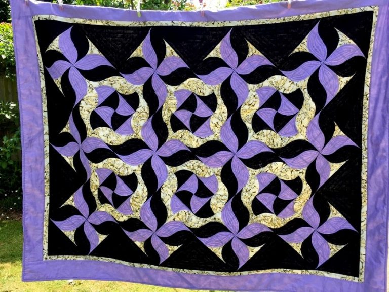 A purple and black abstract patchwork quilt